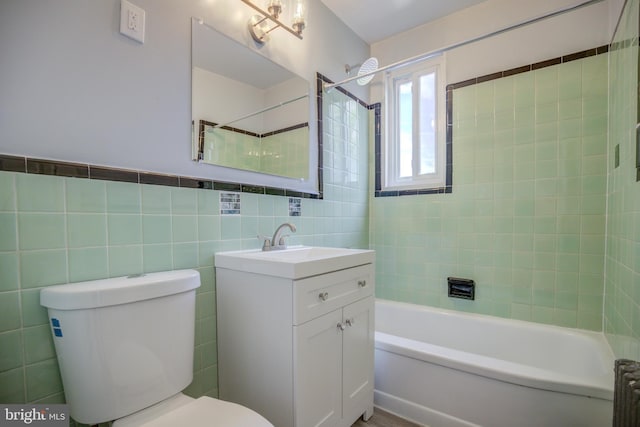 bathroom featuring bathtub / shower combination, toilet, vanity, tile walls, and radiator heating unit