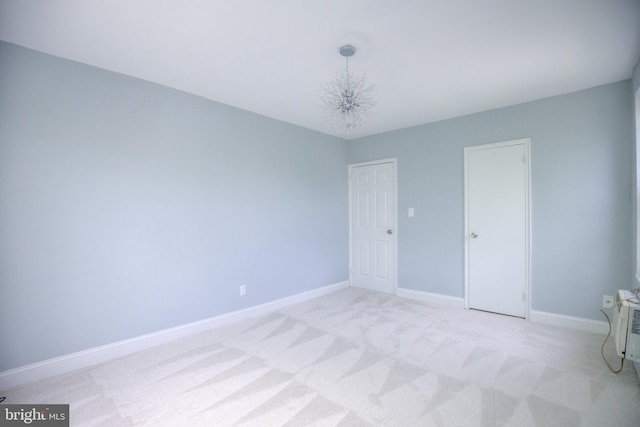 unfurnished bedroom with baseboards and light colored carpet