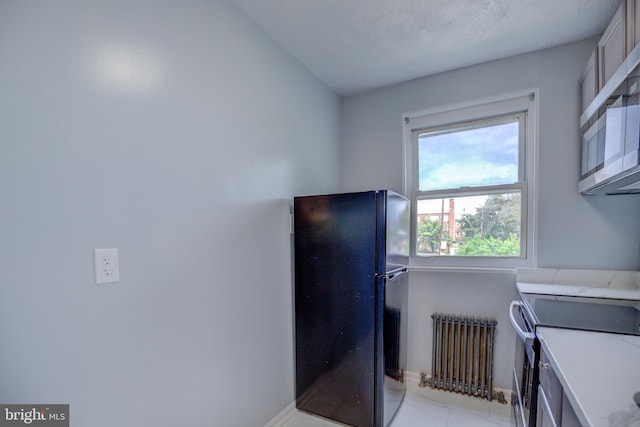 laundry room with radiator