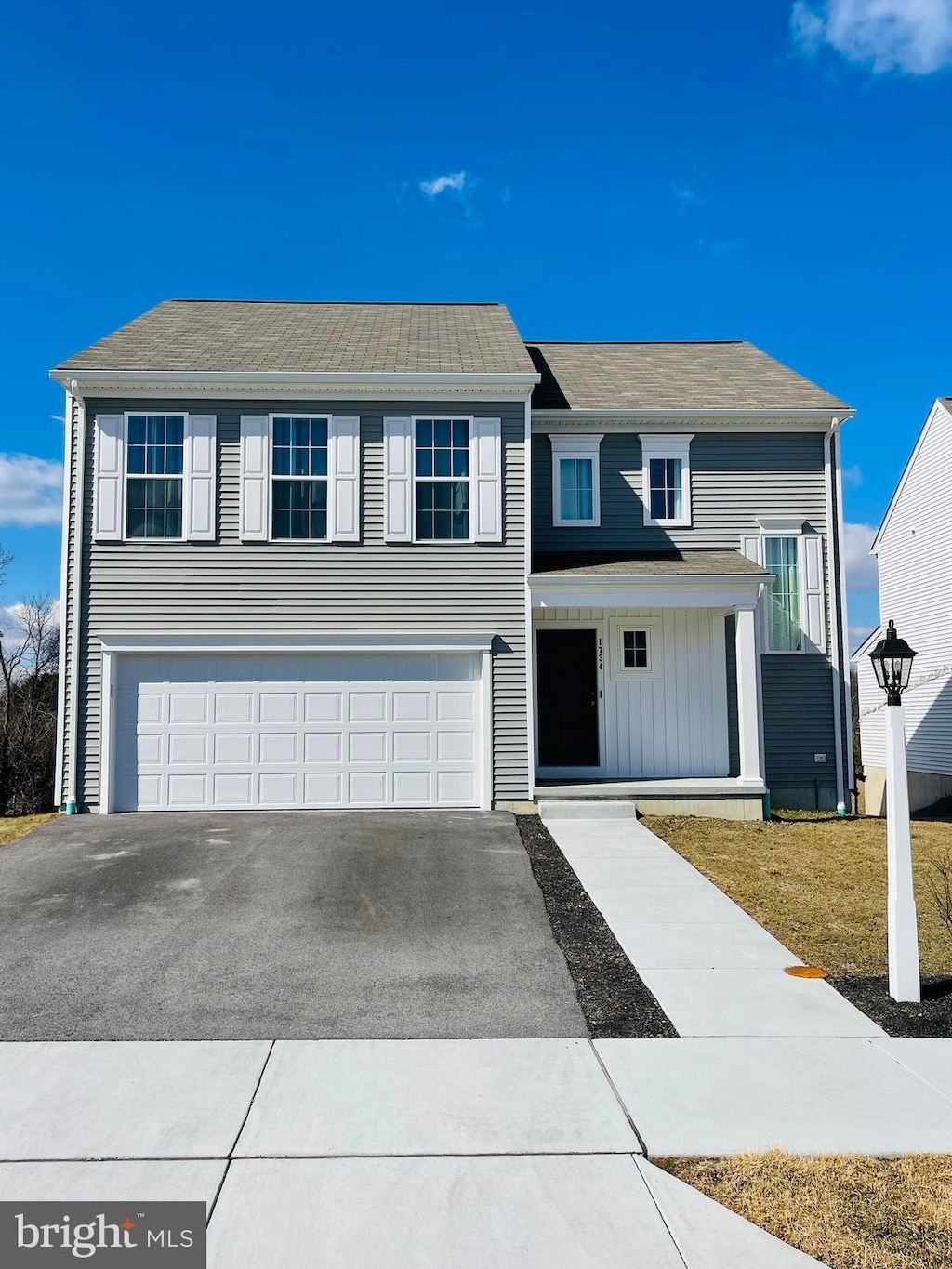 view of front of property with an attached garage, aphalt driveway, and board and batten siding