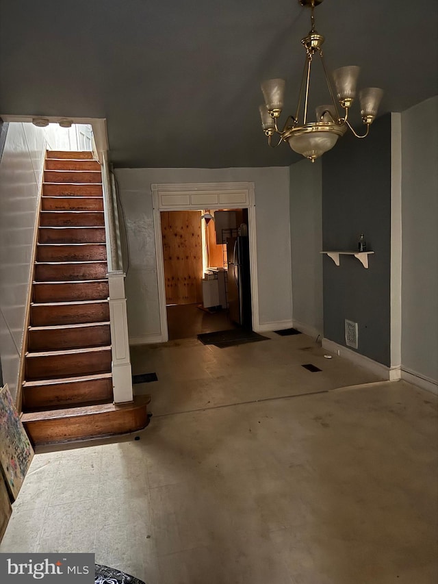 interior space with a notable chandelier, stairway, and baseboards