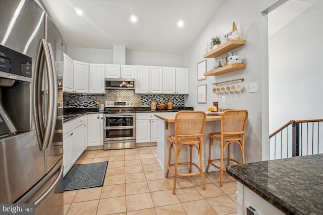 kitchen with open shelves, white cabinets, tasteful backsplash, and stainless steel appliances