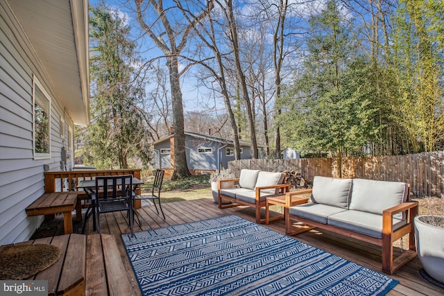 wooden deck with outdoor dining space, an outdoor living space, and fence