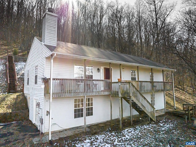 view of front facade featuring stairway and a chimney