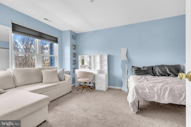 carpeted bedroom featuring visible vents and baseboards