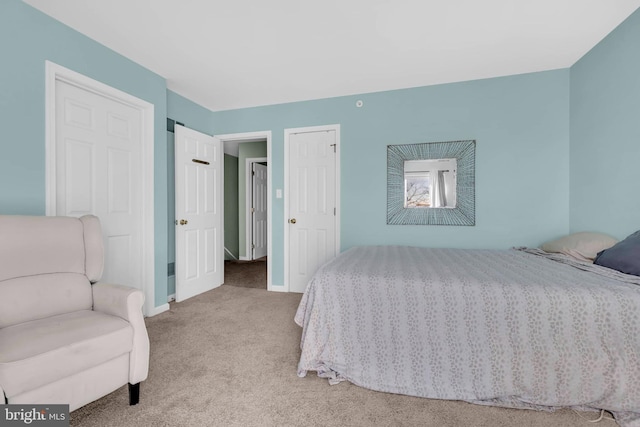 bedroom with baseboards and light colored carpet