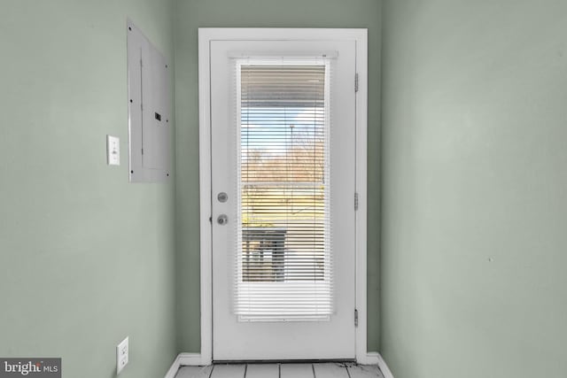 doorway with electric panel and baseboards