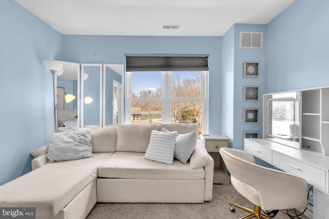 carpeted living room featuring visible vents