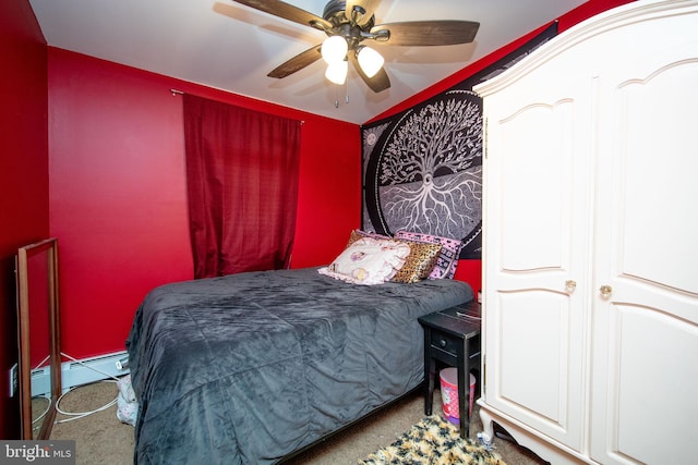 carpeted bedroom with ceiling fan and baseboard heating