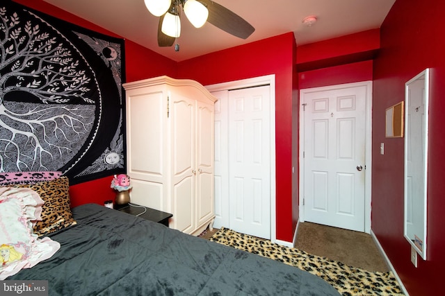 unfurnished bedroom with a closet, carpet flooring, ceiling fan, and baseboards