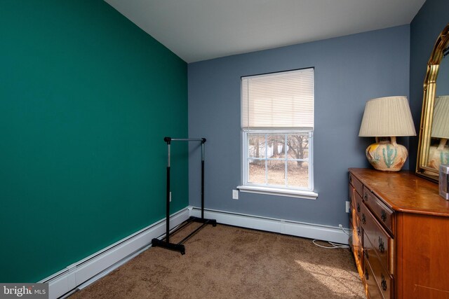 bedroom featuring a baseboard heating unit, carpet floors, and baseboards