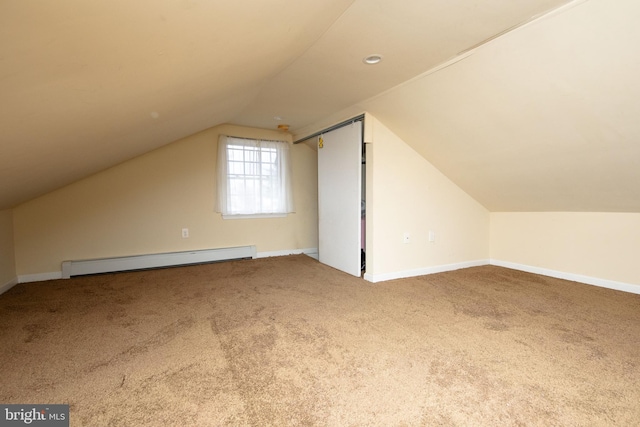 additional living space featuring lofted ceiling, baseboards, baseboard heating, and carpet flooring