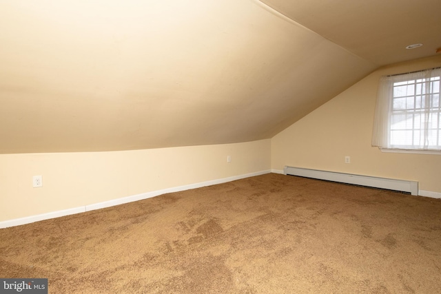 bonus room with a baseboard heating unit, vaulted ceiling, carpet flooring, and baseboards