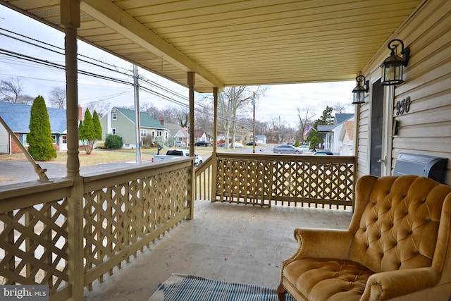 view of patio / terrace with a residential view and covered porch