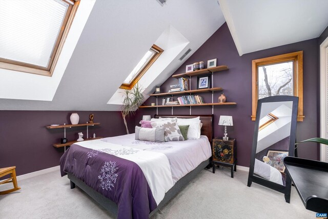 bedroom featuring carpet floors, vaulted ceiling with skylight, and baseboards