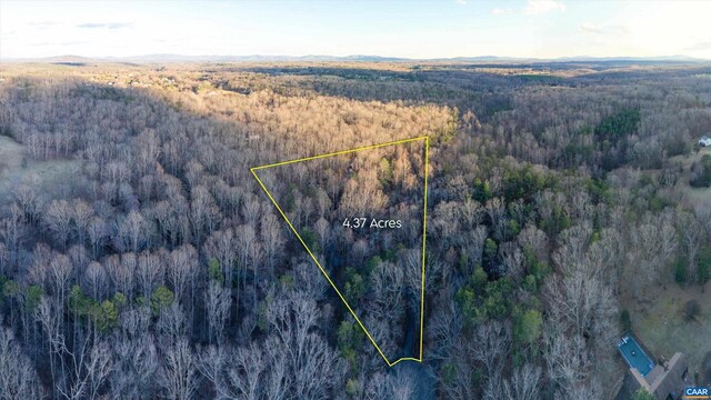 birds eye view of property with a forest view