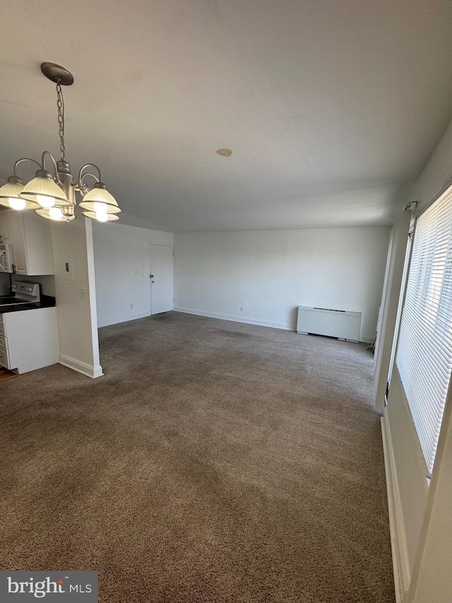 unfurnished living room with a baseboard heating unit, dark carpet, and baseboards