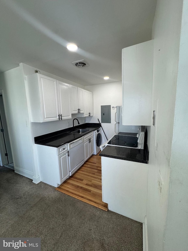 kitchen with electric panel, visible vents, dishwasher, washer / clothes dryer, and white cabinetry