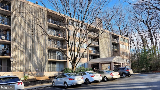 view of building exterior with uncovered parking