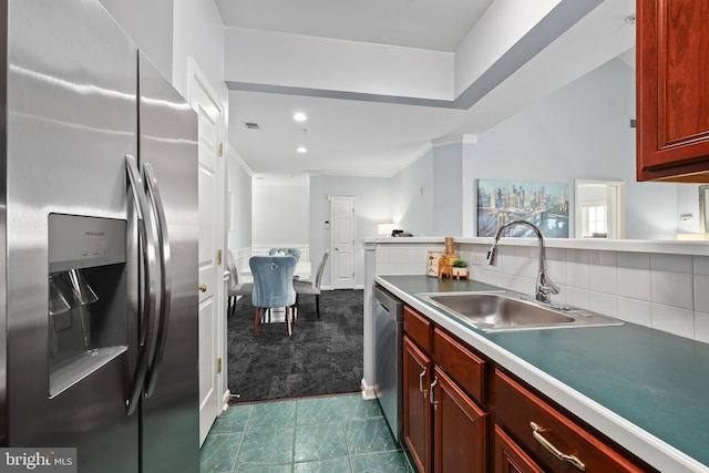 kitchen featuring a sink, dark brown cabinets, appliances with stainless steel finishes, backsplash, and dark colored carpet