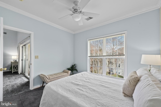 bedroom with baseboards, dark carpet, visible vents, and crown molding