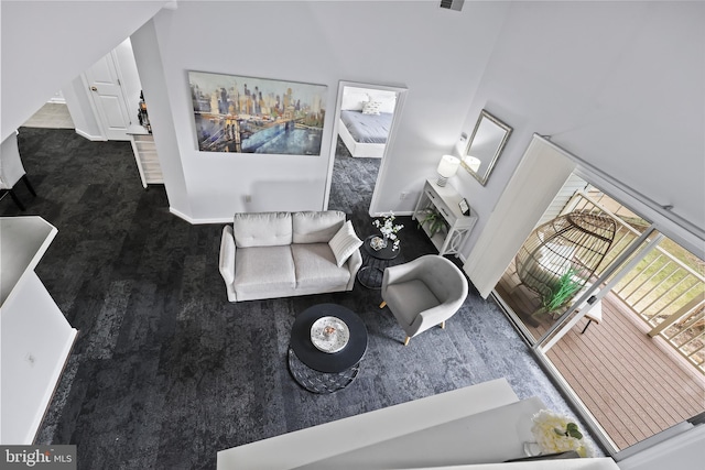 living area with carpet flooring and baseboards