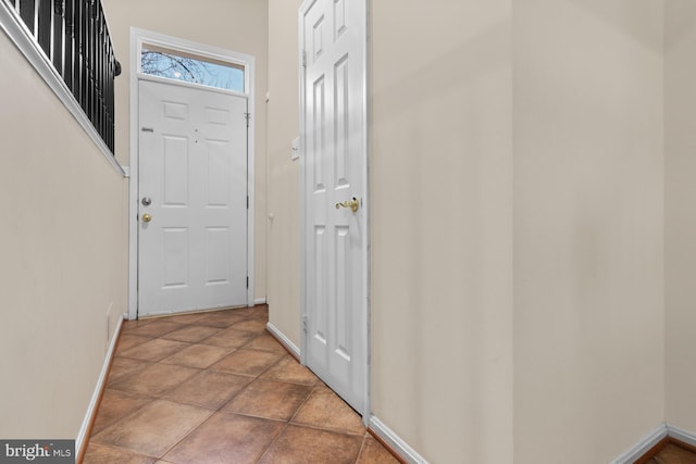 doorway to outside with baseboards