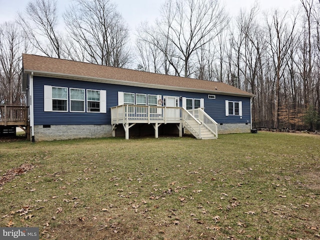 view of front of home featuring crawl space, roof with shingles, a wooden deck, and a front lawn