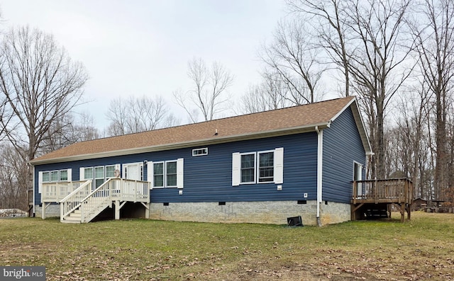 back of property featuring a deck, a yard, crawl space, and roof with shingles