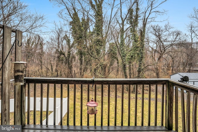 wooden terrace with a lawn