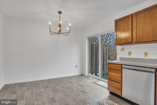 kitchen featuring baseboards, brown cabinetry, dishwasher, an inviting chandelier, and light countertops