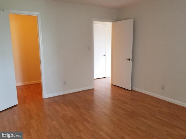 empty room featuring baseboards and wood finished floors