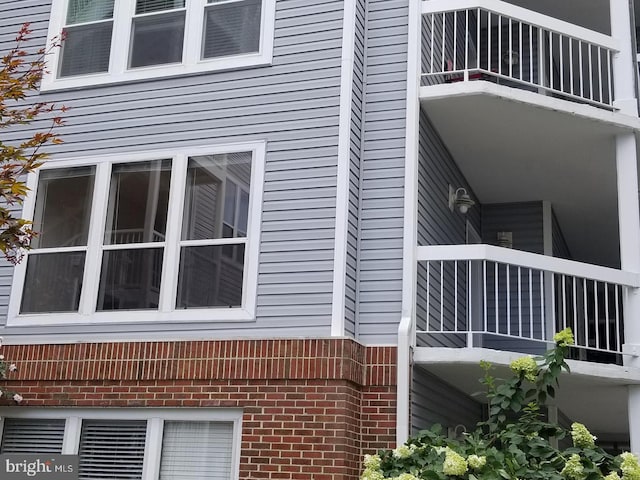 view of side of home featuring brick siding