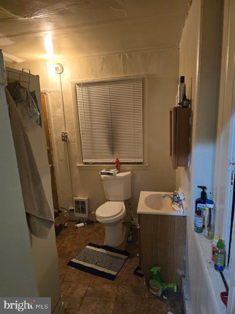 bathroom featuring vanity and toilet