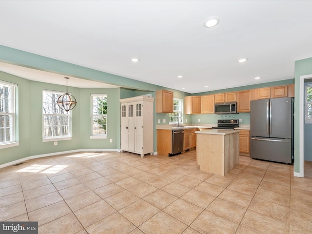 kitchen featuring light tile patterned floors, plenty of natural light, appliances with stainless steel finishes, and light countertops