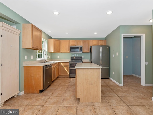 kitchen featuring a sink, light countertops, a center island, and stainless steel appliances