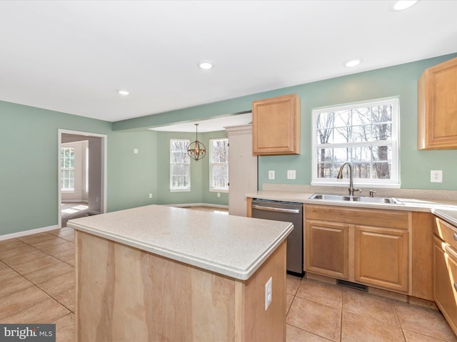 kitchen featuring visible vents, a sink, a center island, light countertops, and dishwasher