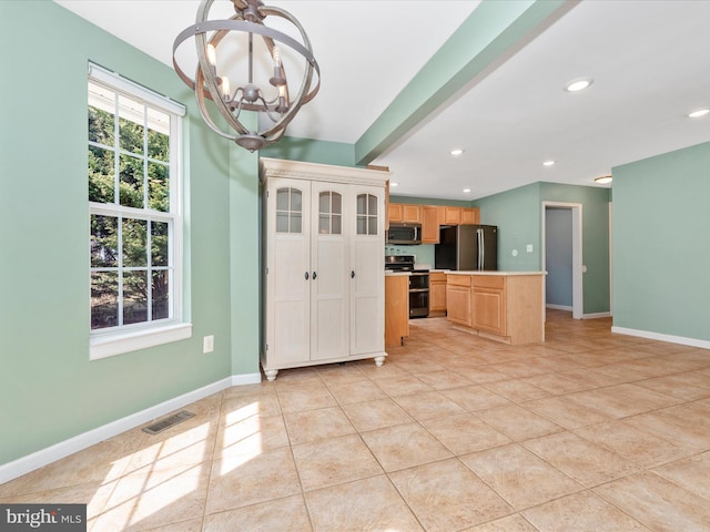 kitchen with light tile patterned floors, an inviting chandelier, appliances with stainless steel finishes, and baseboards