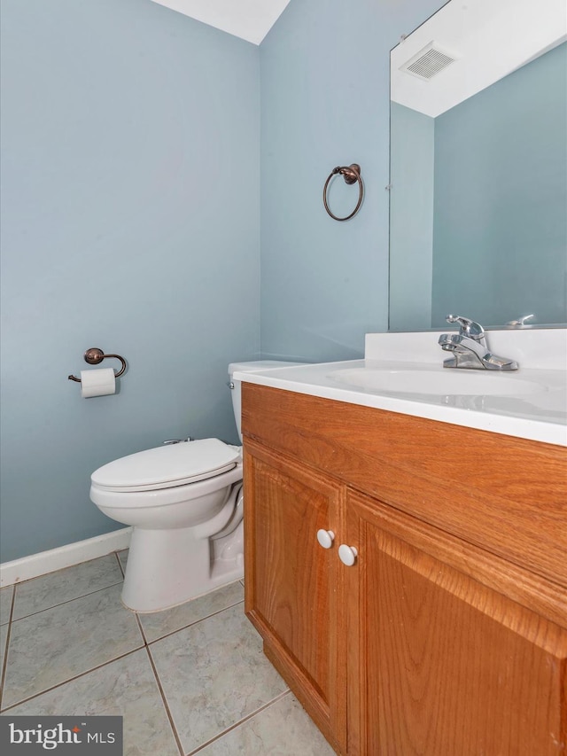 half bath with visible vents, baseboards, toilet, and vanity