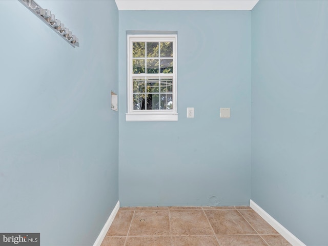 washroom with baseboards