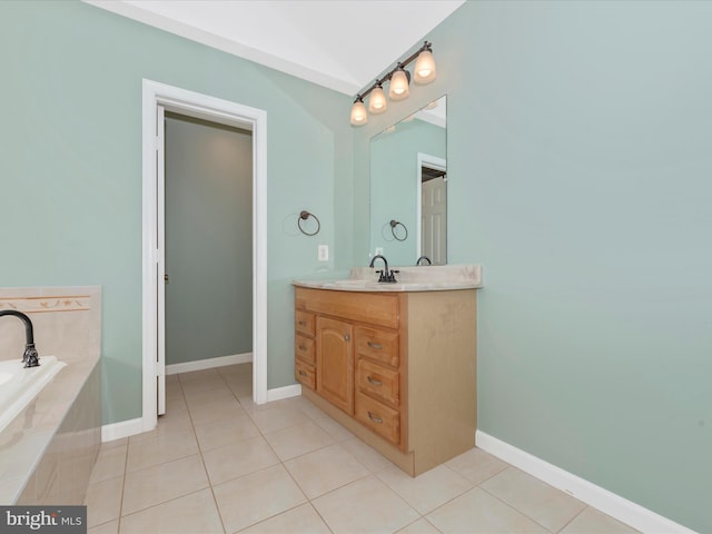 bathroom featuring tile patterned flooring, baseboards, vanity, and a relaxing tiled tub