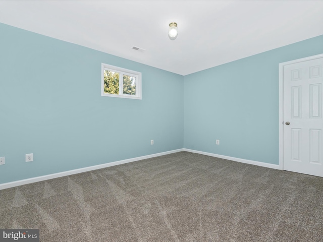 empty room featuring carpet flooring, baseboards, and visible vents