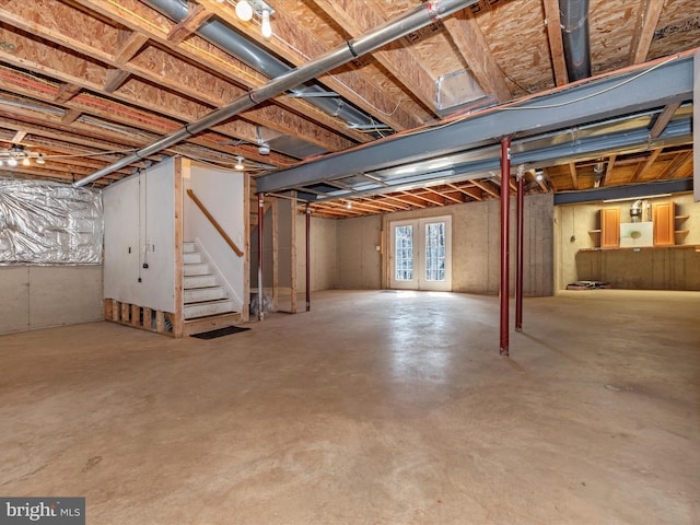 basement featuring stairs and french doors