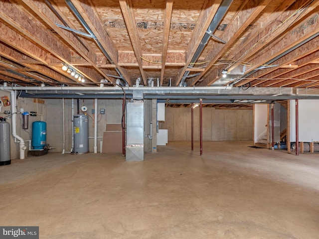 unfinished basement featuring electric water heater