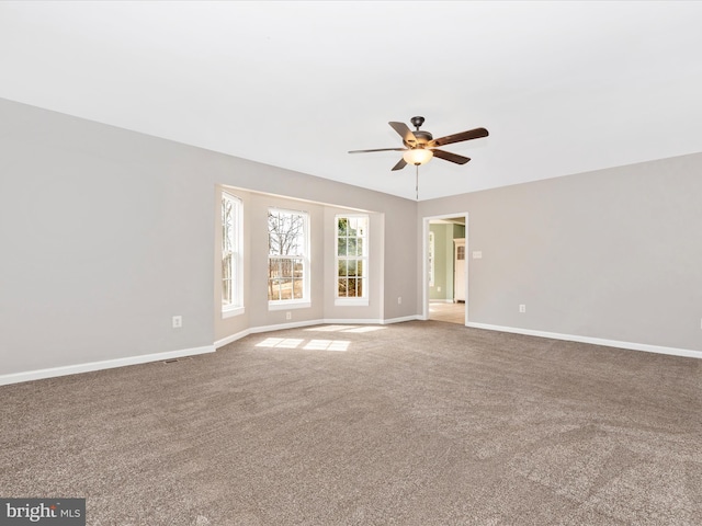 empty room featuring carpet flooring and baseboards