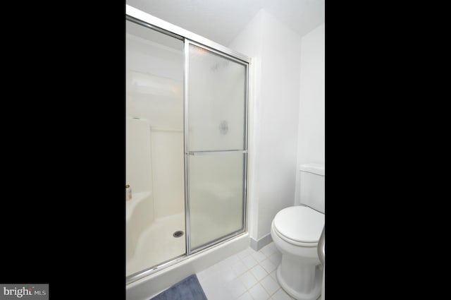 full bathroom with tile patterned flooring, a shower stall, and toilet