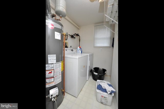 laundry room featuring gas water heater, washer and clothes dryer, light floors, and laundry area