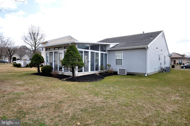 back of house with a sunroom, central AC unit, and a yard