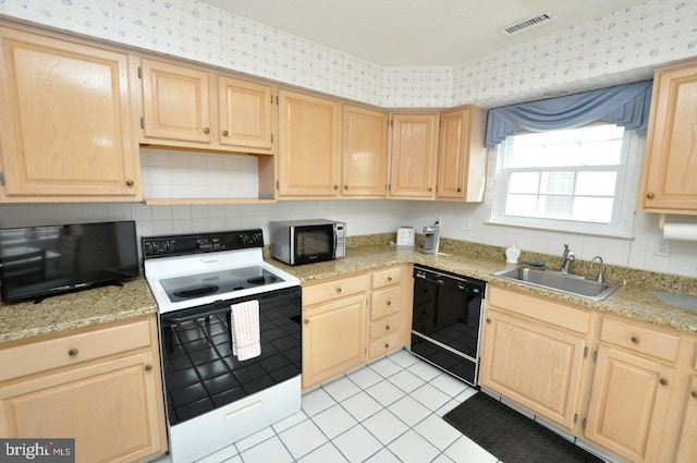 kitchen with a sink, electric stove, dishwasher, light brown cabinetry, and wallpapered walls