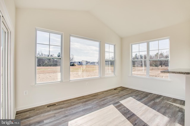 unfurnished sunroom with lofted ceiling and visible vents